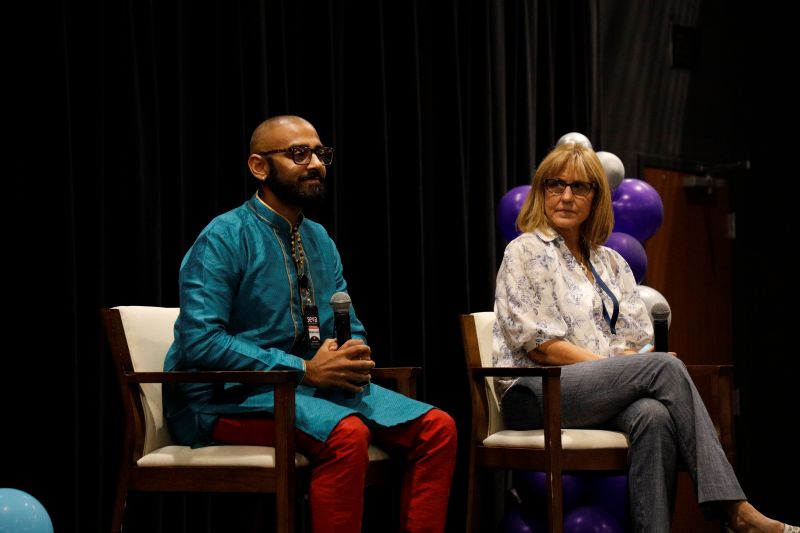 Man and woman sitting on stage