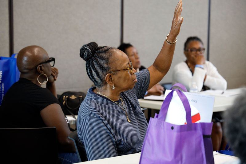 Caregiver raising hand to ask question