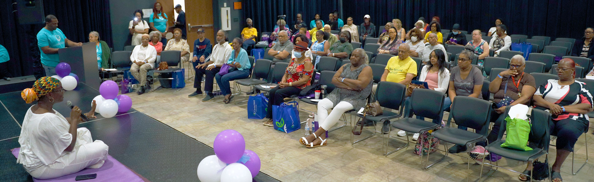 Speaker in front of audience at Caregivers Symposium